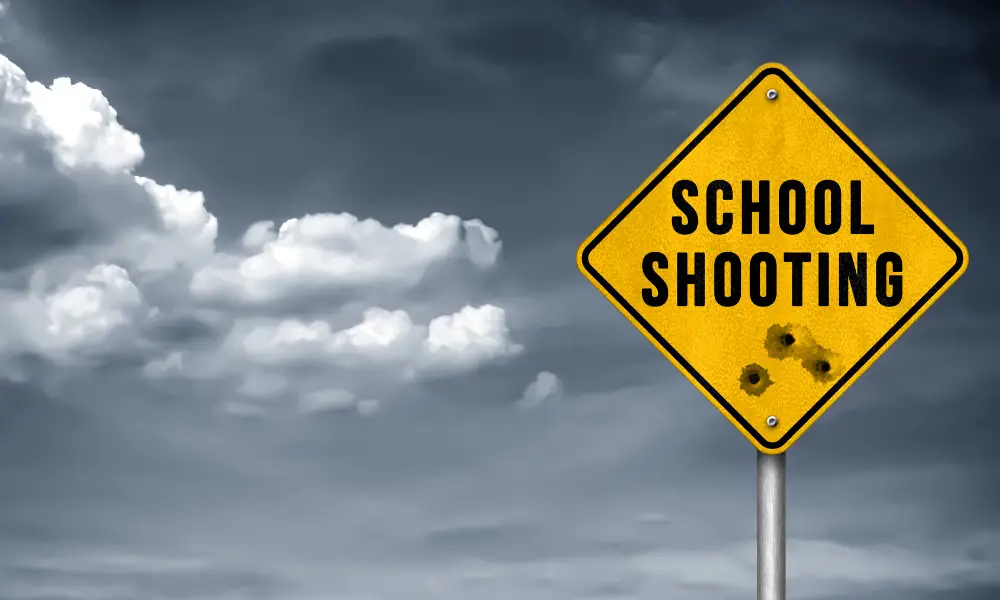 school road sign with bullet holes, avoid sharing details of violence with children
